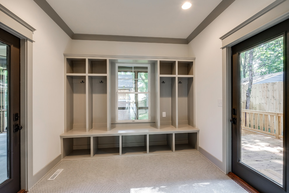 Design ideas for a mid-sized traditional mudroom in Nashville with white walls, ceramic floors, a single front door and a dark wood front door.