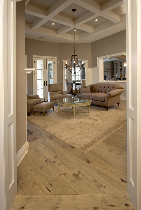 Inspiration for a large traditional family room in Ottawa with beige walls and light hardwood floors.