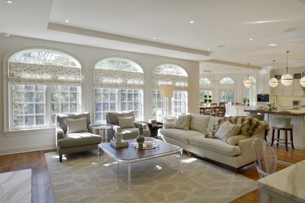 Open concept kitchen - large transitional l-shaped medium tone wood floor and brown floor open concept kitchen idea in New York with an undermount sink, shaker cabinets, white cabinets, quartzite countertops, white backsplash, marble backsplash, stainless steel appliances and an island
