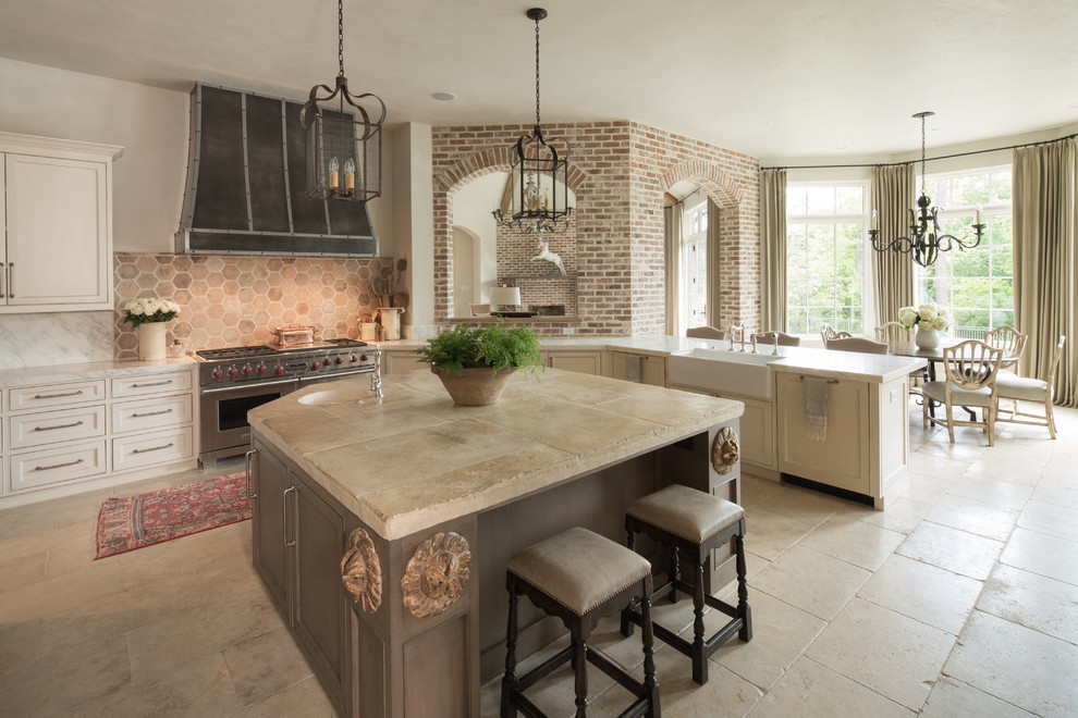 Inspiration for a traditional eat-in kitchen in Houston with a farmhouse sink, beaded inset cabinets, beige cabinets, beige splashback, stainless steel appliances, with island and beige floor.