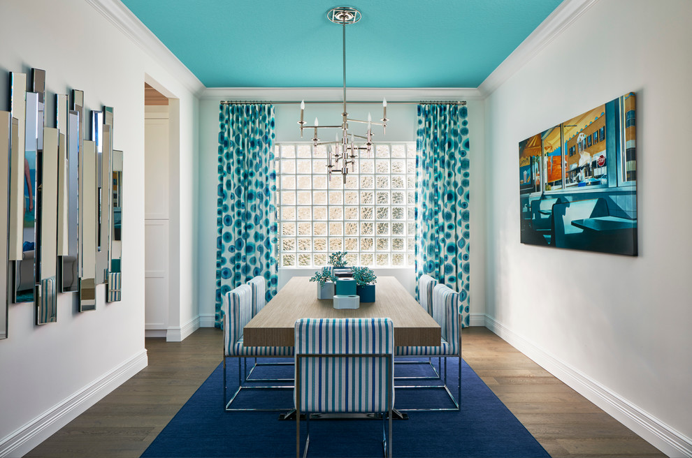 Large beach style light wood floor enclosed dining room photo in Miami with white walls