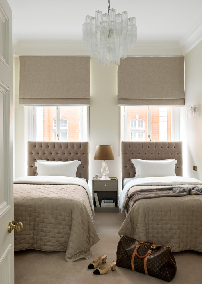 Inspiration for a transitional bedroom in London with beige walls, carpet and beige floor.