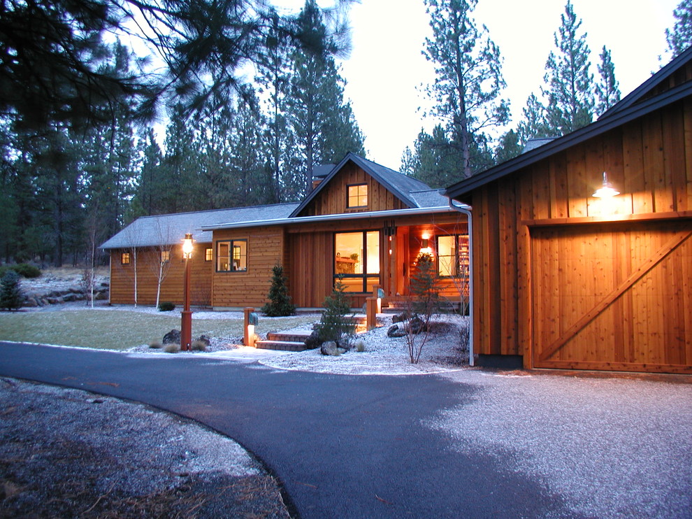 This is an example of a mid-sized country two-storey exterior in Denver with wood siding and a gable roof.