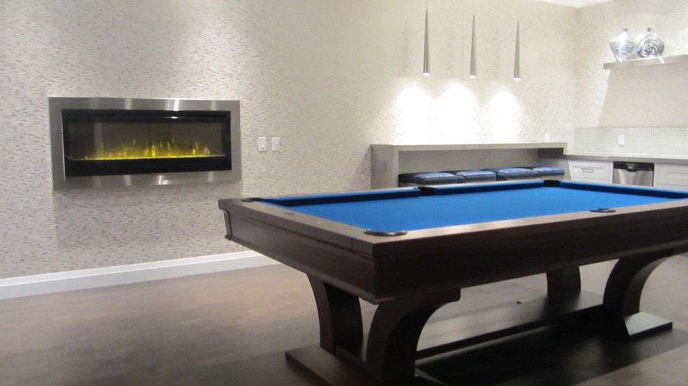 Photo of a modern fully buried basement in Calgary with grey walls, dark hardwood floors and a standard fireplace.