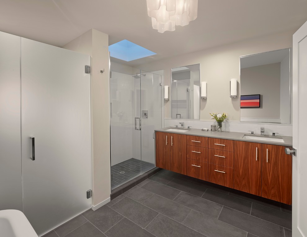 This is an example of a contemporary bathroom in San Francisco with a hinged shower door and grey benchtops.