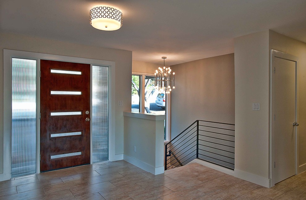 Inspiration for a contemporary entryway in Austin with beige walls, a single front door and a dark wood front door.