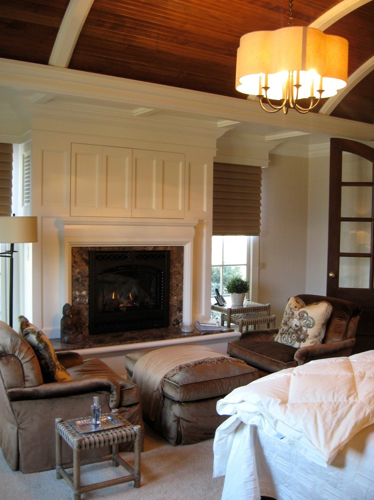 Design ideas for a mid-sized traditional master bedroom in Other with white walls, carpet, a standard fireplace and a stone fireplace surround.
