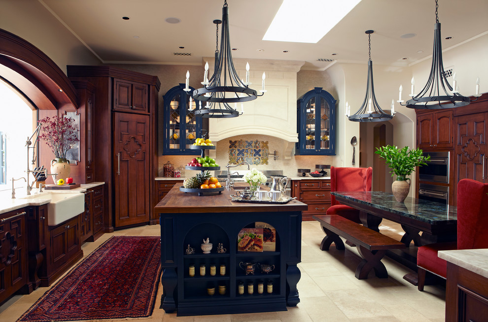 Inspiration for a mediterranean kitchen in Phoenix with recessed-panel cabinets and a farmhouse sink.