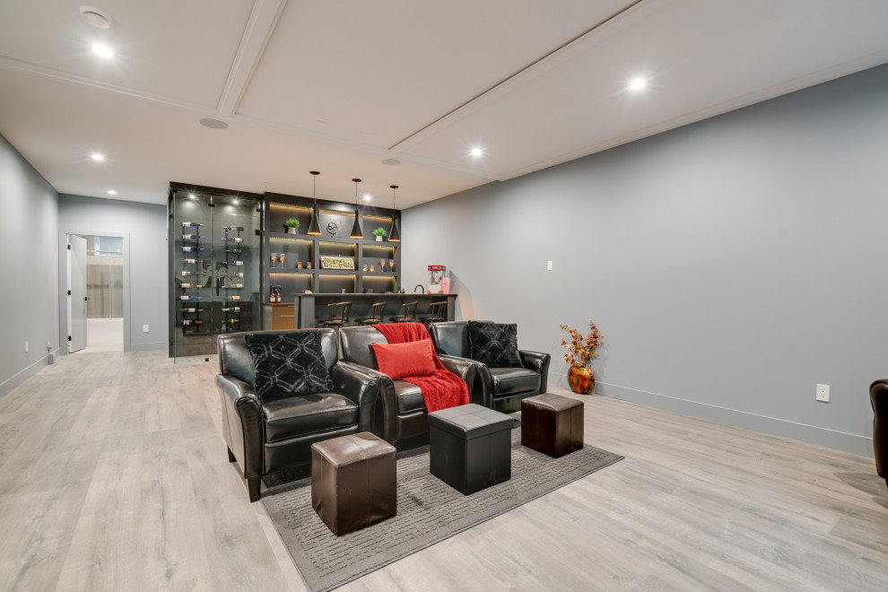 Inspiration for a mid-sized contemporary open concept home theatre in Vancouver with a projector screen, grey walls, laminate floors and grey floor.