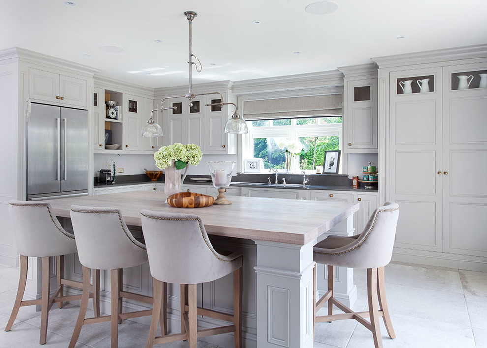 Design ideas for a country l-shaped kitchen in Dublin with beaded inset cabinets, grey cabinets, wood benchtops, grey splashback, stainless steel appliances and with island.