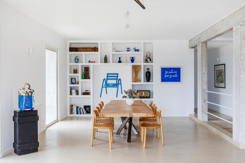 Photo of a large mediterranean open plan dining in Nice with white walls, concrete floors and beige floor.