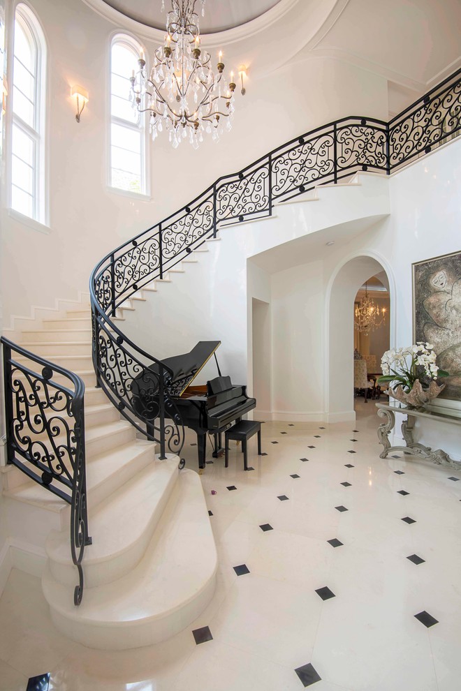 Photo of an expansive traditional foyer in Orlando with white walls.