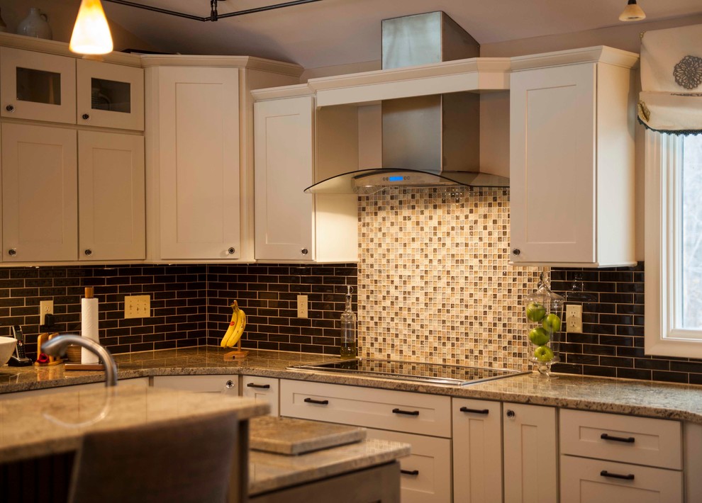 Mid-sized transitional single-wall medium tone wood floor eat-in kitchen photo in Boston with a single-bowl sink, recessed-panel cabinets, white cabinets, granite countertops, multicolored backsplash, mosaic tile backsplash, stainless steel appliances and an island
