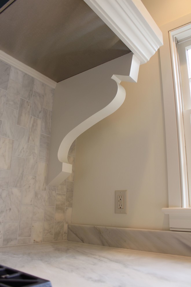 Example of a transitional staircase design in Charleston with an undermount sink, beaded inset cabinets, white cabinets, stainless steel appliances and an island