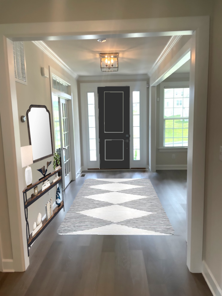 This is an example of a medium sized country foyer in Philadelphia with grey walls, medium hardwood flooring, a single front door, a black front door and brown floors.