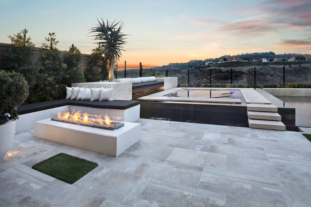 Inspiration for a small modern custom-shaped natural pool in Orange County with a hot tub.