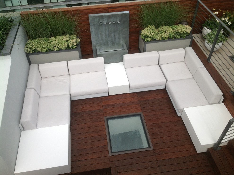 Large contemporary rooftop deck in New York with a water feature and no cover.