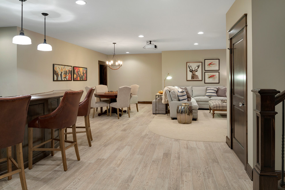 Inspiration for a large country fully buried basement in Minneapolis with beige walls, beige floor and light hardwood floors.