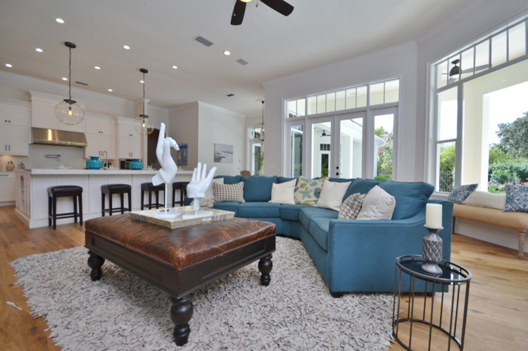 Contemporary living room in Orlando with white walls and light hardwood floors.