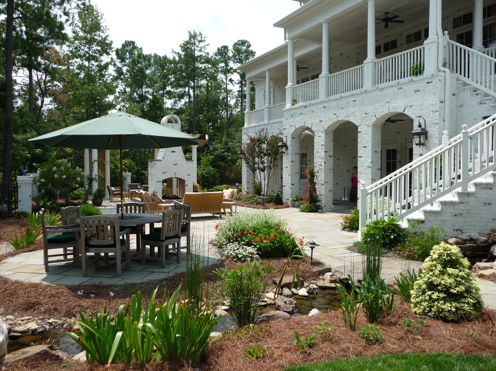 Elegant white three-story brick exterior home photo in Raleigh