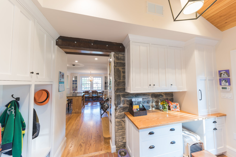 Inspiration for a large traditional kitchen in Philadelphia with recessed-panel cabinets, white cabinets, wood benchtops, brick floors and orange floor.