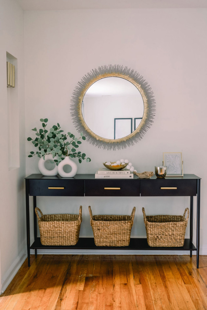 Example of a small transitional medium tone wood floor and brown floor front door design in New York with gray walls