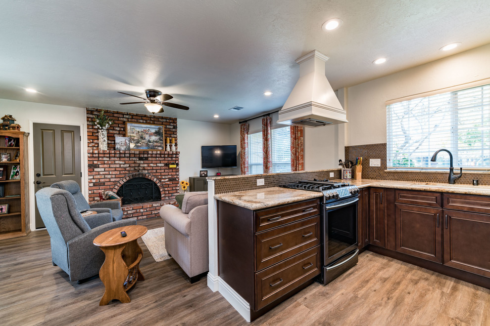 Mid-sized transitional u-shaped medium tone wood floor and brown floor eat-in kitchen photo with an undermount sink, recessed-panel cabinets, white cabinets, granite countertops, brown backsplash, mosaic tile backsplash, stainless steel appliances and no island
