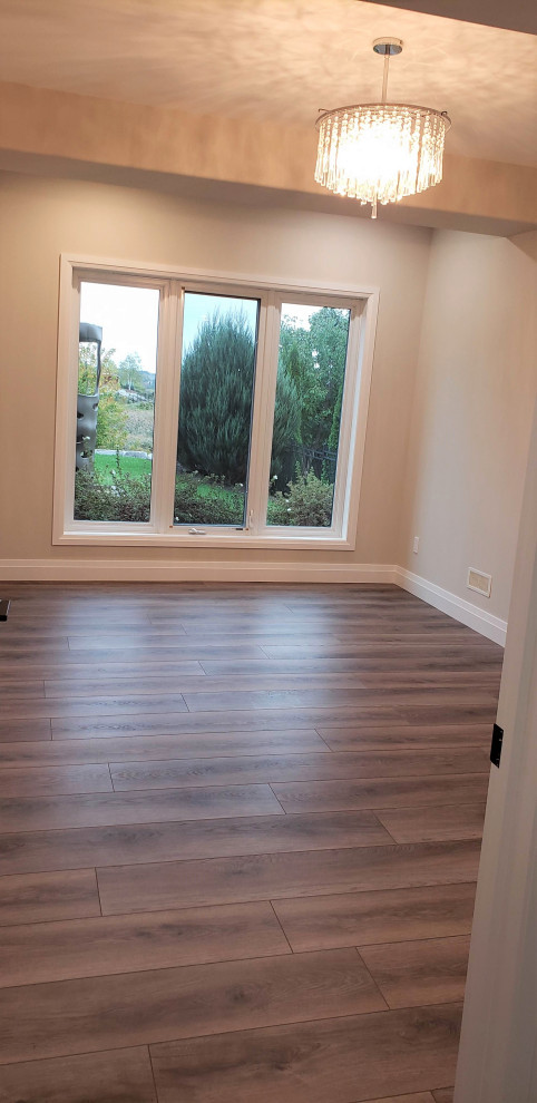 Basement - large transitional walk-out vinyl floor basement idea