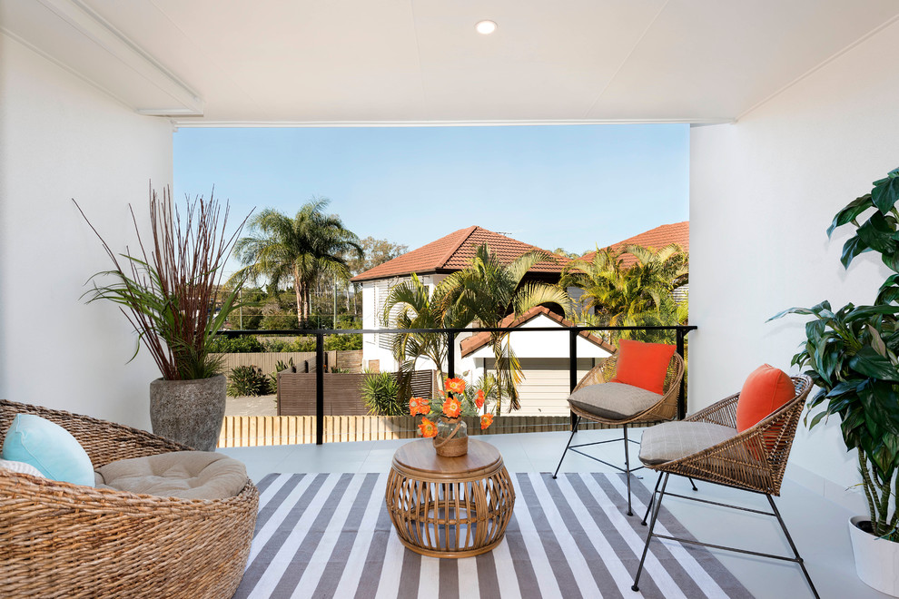 Design ideas for a small modern front yard verandah in Brisbane with a roof extension and tile.