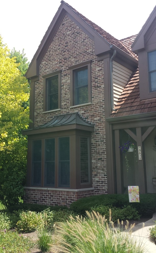 Inspiration for a large traditional brown exterior in Chicago with wood siding.