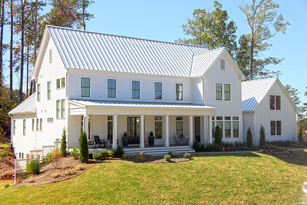 This is an example of a large country three-storey white exterior in Atlanta with mixed siding and a gable roof.