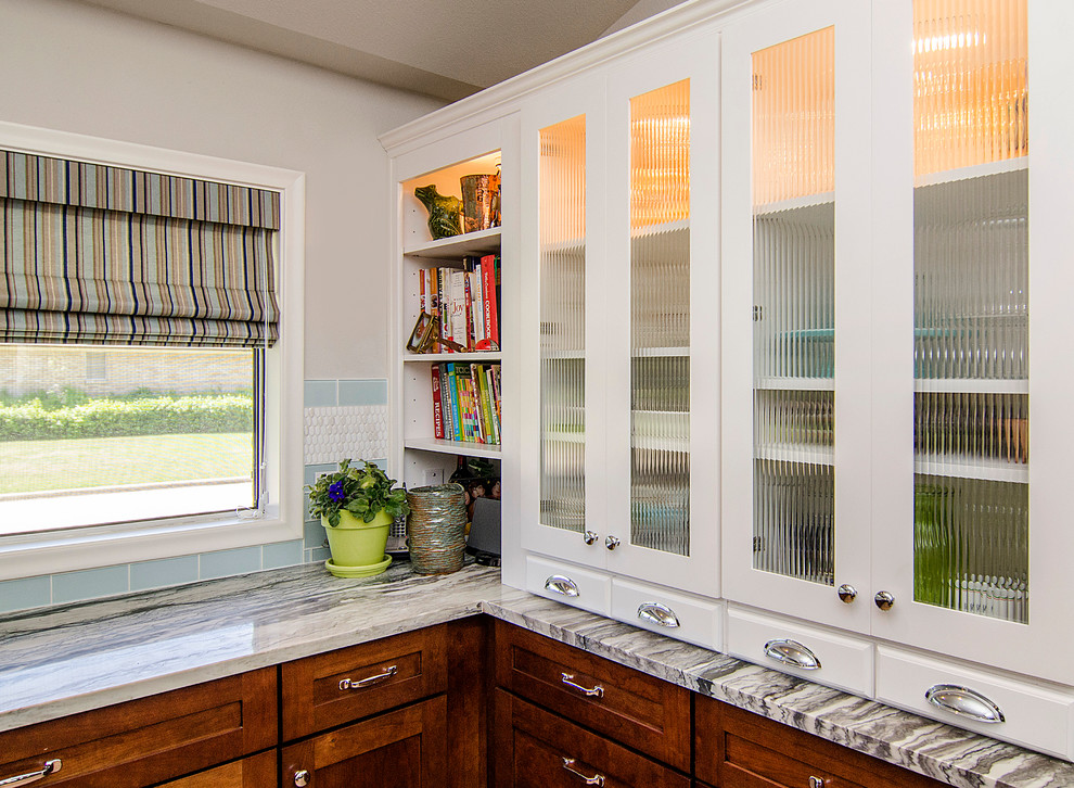 Inspiration for a mid-sized transitional u-shaped vinyl floor eat-in kitchen remodel in Dallas with an undermount sink, shaker cabinets, medium tone wood cabinets, quartzite countertops, blue backsplash, glass tile backsplash, stainless steel appliances, white walls and an island