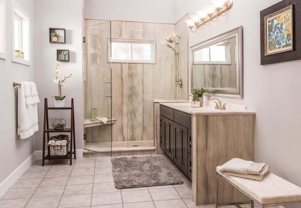 Mid-sized transitional master bathroom in Albuquerque with shaker cabinets, dark wood cabinets, an alcove shower, stone slab, purple walls, ceramic floors, an integrated sink, grey floor and a hinged shower door.