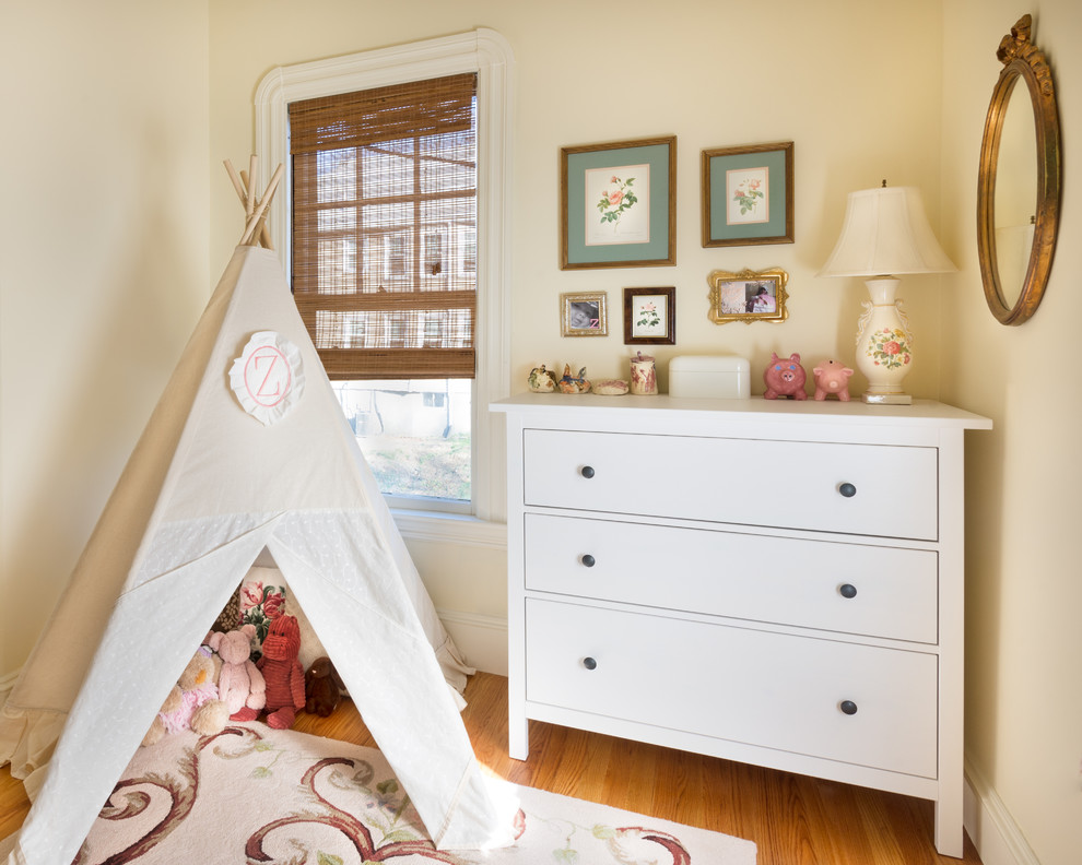 Country kids' bedroom in Boston with yellow walls and medium hardwood floors for kids 4-10 years old and girls.