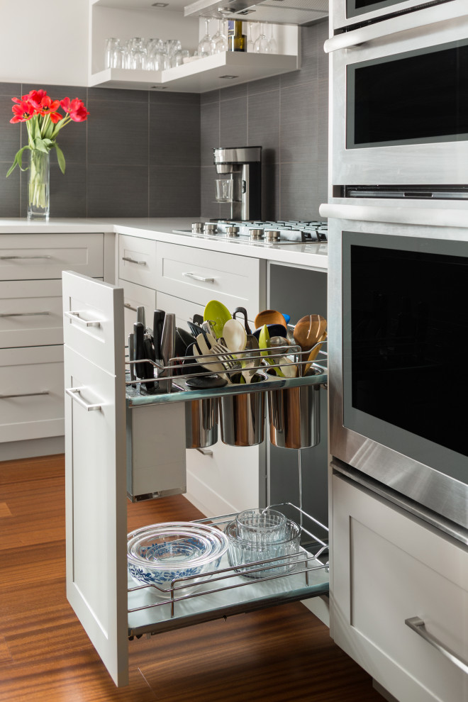 Mid-sized minimalist l-shaped medium tone wood floor and white floor kitchen photo with open cabinets, white cabinets and an island