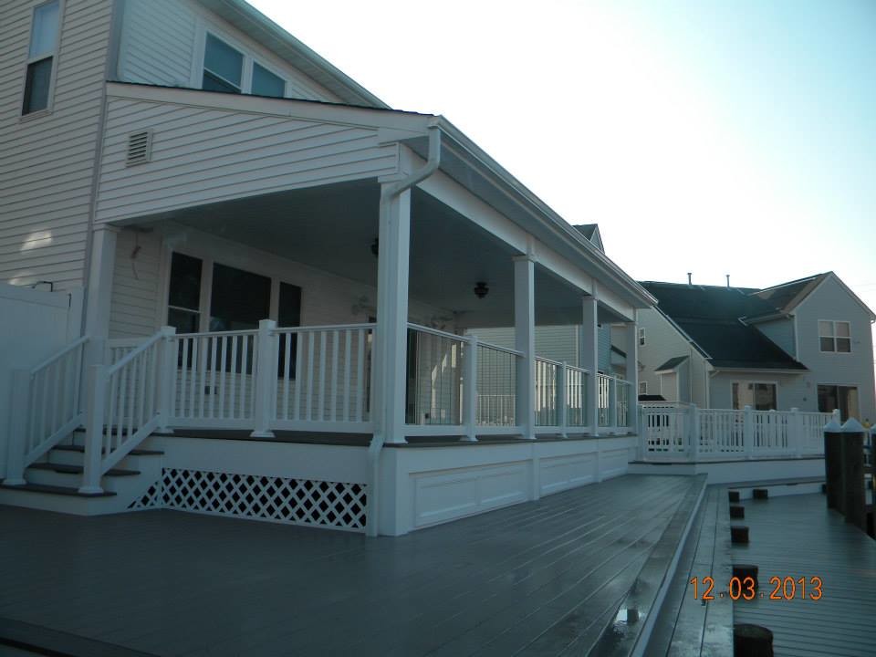 Deck - large transitional backyard deck idea in New York with an awning