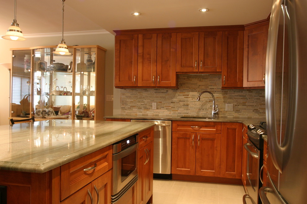 Inspiration for a large transitional l-shaped porcelain tile eat-in kitchen remodel in New York with an undermount sink, shaker cabinets, medium tone wood cabinets, quartzite countertops, multicolored backsplash, mosaic tile backsplash, stainless steel appliances and an island