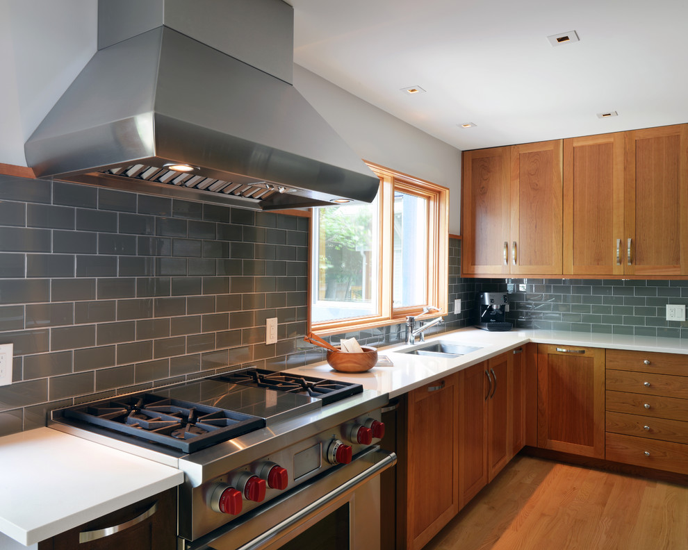 Photo of a contemporary kitchen in Ottawa with medium wood cabinets, grey splashback and subway tile splashback.