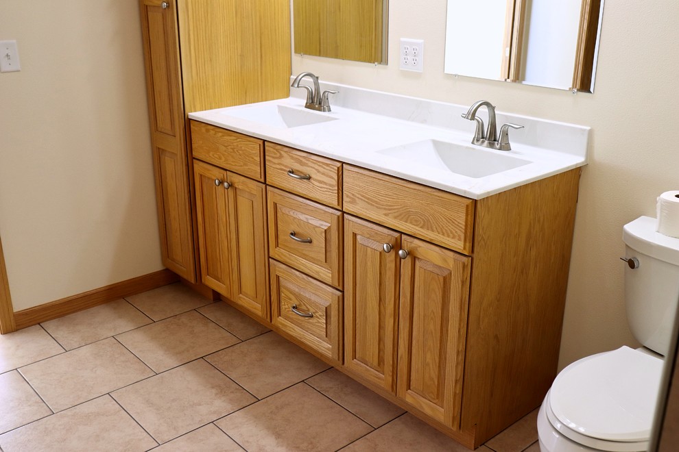Inspiration for a mid-sized traditional master bathroom in Cedar Rapids with raised-panel cabinets, a curbless shower, porcelain floors, an integrated sink and an open shower.