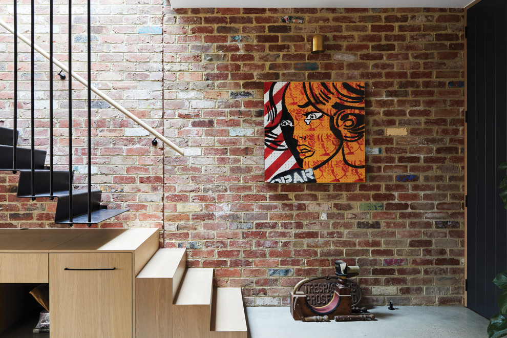 Mid-sized industrial metal l-shaped staircase in Melbourne with metal risers, wood railing and brick walls.