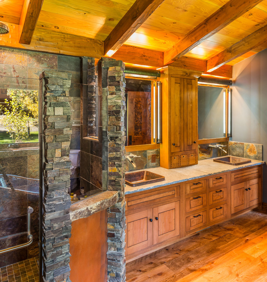 Design ideas for a country master bathroom in Denver with recessed-panel cabinets, medium wood cabinets, a corner shower, stone tile, blue walls, light hardwood floors, a drop-in sink and granite benchtops.