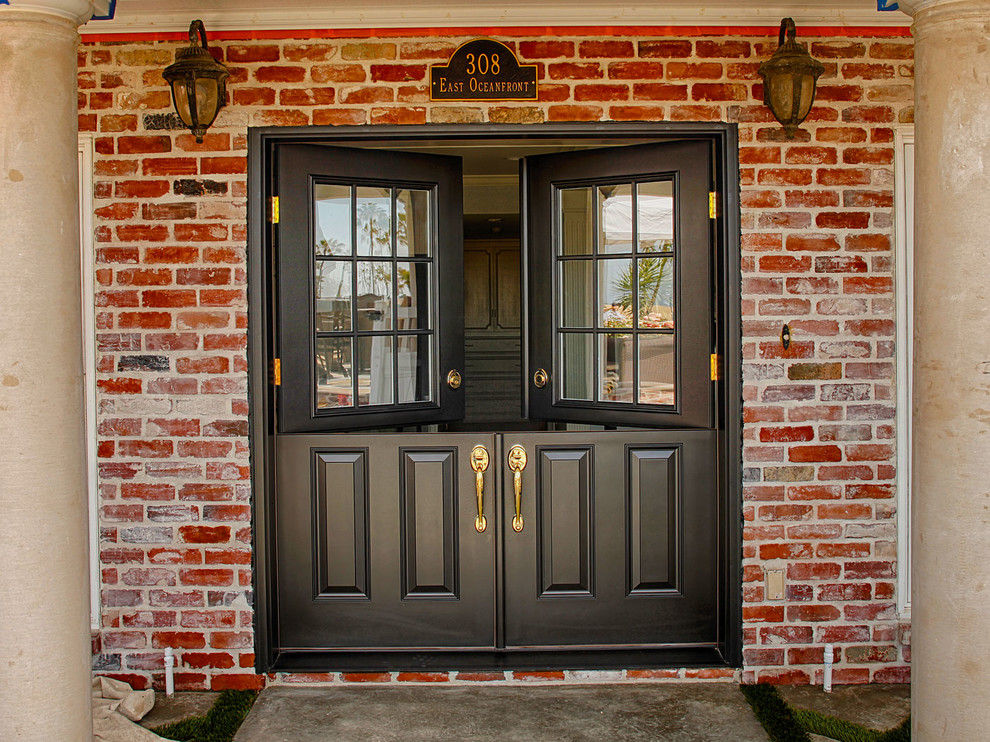 This is an example of a large traditional front door in Orange County with brown walls, a dutch front door and a white front door.