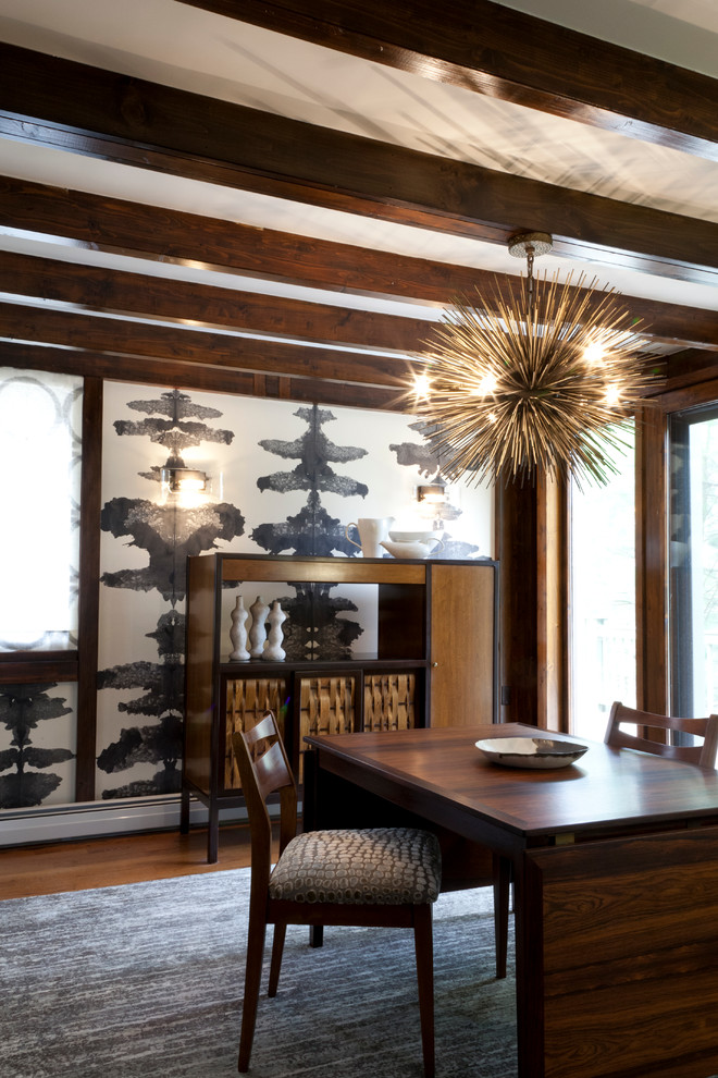 Photo of a large contemporary dining room in New York with medium hardwood floors and wallpaper.