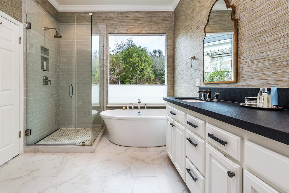 Transitional bathroom in San Francisco with raised-panel cabinets, white cabinets, a freestanding tub, a corner shower, beige tile, brown walls, an undermount sink, beige floor, a hinged shower door and black benchtops.