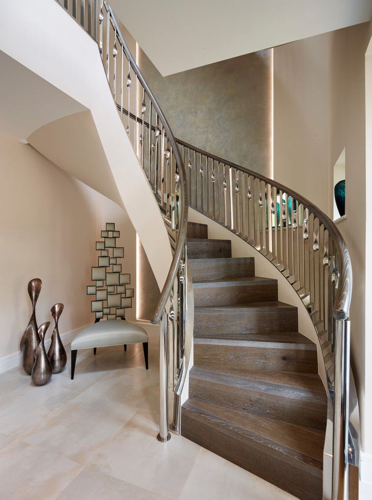 Contemporary wood curved staircase in Berkshire with wood risers and mixed railing.