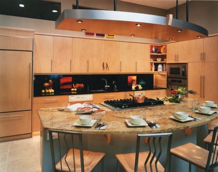 This is an example of a mid-sized contemporary single-wall eat-in kitchen in Albuquerque with an undermount sink, flat-panel cabinets, light wood cabinets, marble benchtops, black splashback, stone slab splashback, stainless steel appliances, ceramic floors, with island and beige floor.