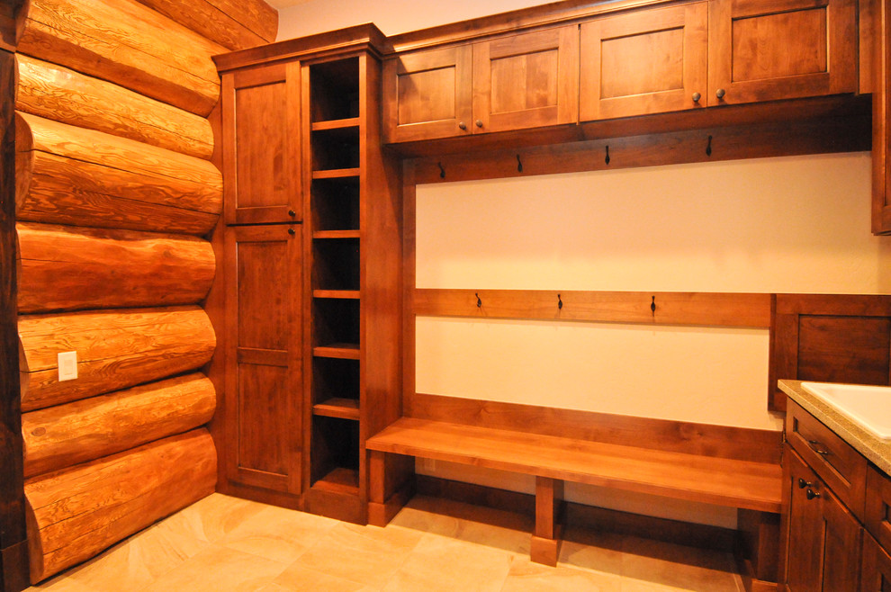 Design ideas for a mid-sized country mudroom in Denver with travertine floors.