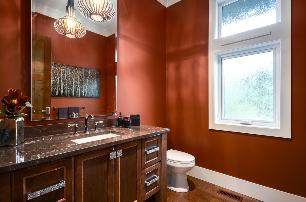 Photo of a transitional powder room in Vancouver with an undermount sink and brown benchtops.