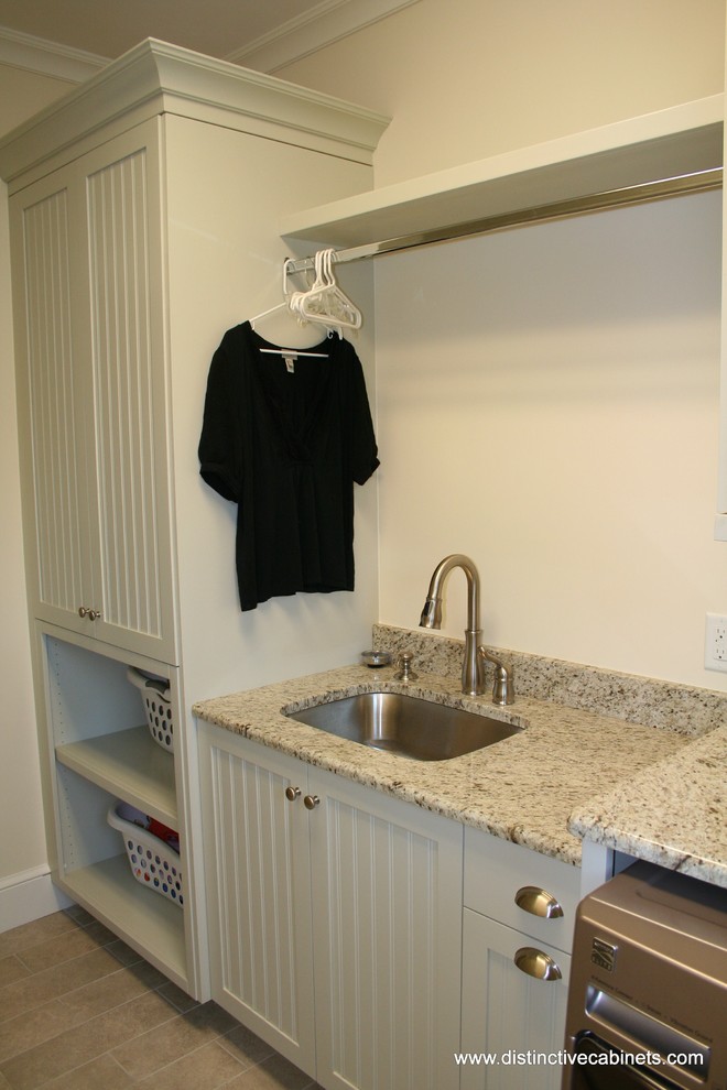 Traditional laundry room in Charlotte with recessed-panel cabinets and white cabinets.