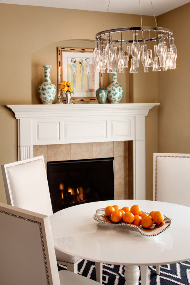 Inspiration for a transitional dining room in Milwaukee with beige walls, a standard fireplace and a tile fireplace surround.